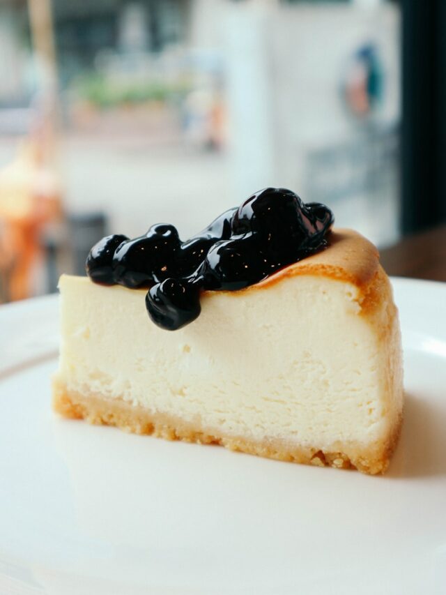 sliced cake with berries on top